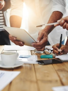 up close photo of people collaborating around a table