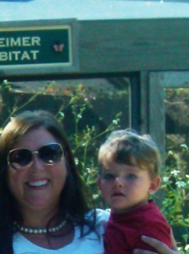 mom and son in front of butterfly exhibit