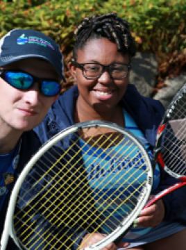 boy and girl playing tennis