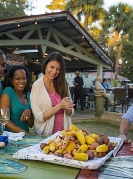 group of people around a table with a lowcountry boil