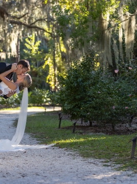 couple embracing among spanish moss covered trees