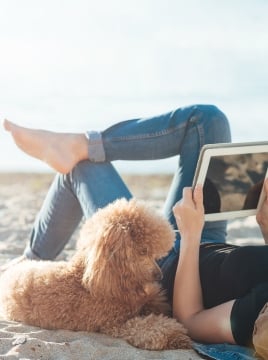 woman on the beach with her dog