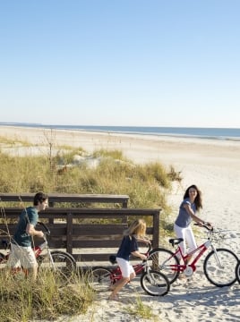 family going to the beach on biked