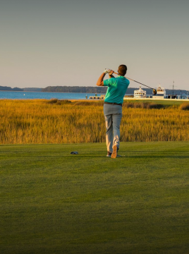 man teeing off at a golf course