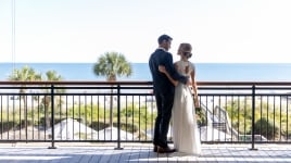 couple standing on an outdoor balcony