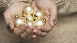 person holding christmas ornaments