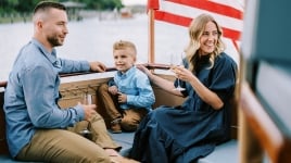 Family on boat with American Flag