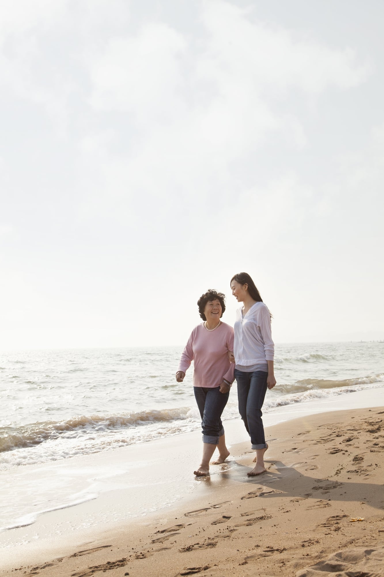 TWO PEOPLE WALKING ON THE BEACH