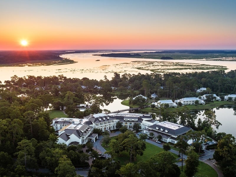 sunset with view of hotel and the water 