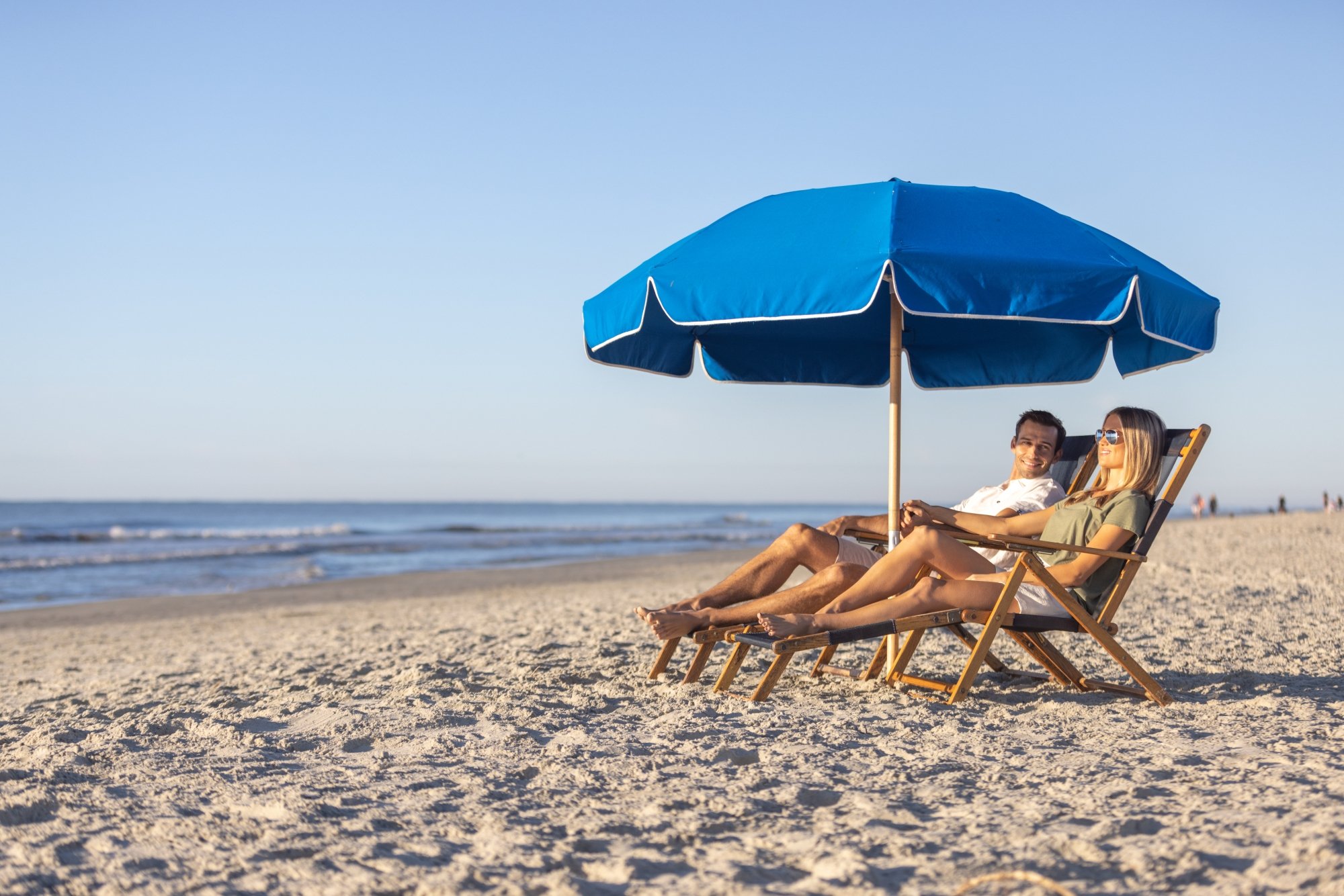 beach chairs and umbrella couple