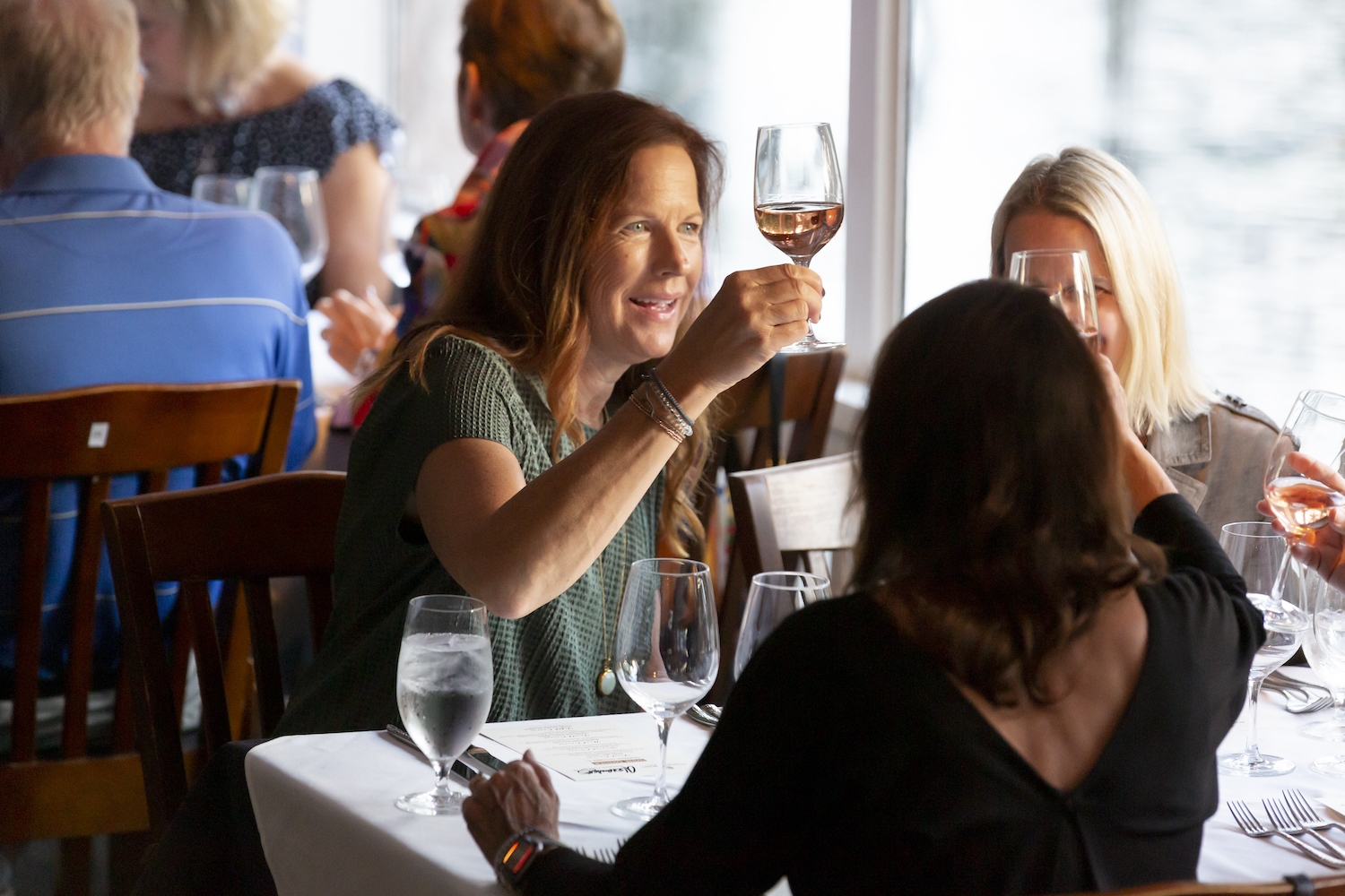 women looking at wine during a wine dinner