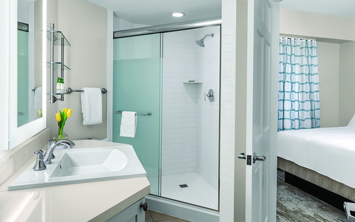 Villa guest bathroom with single vanity, walk-in shower. 